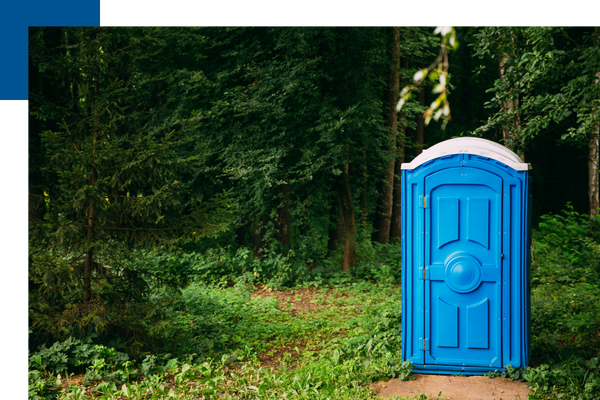 Blue outdoor portable restroom in the woods