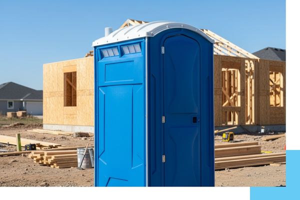 Durable blue portable toilets placed on a gravel construction site for a renovation project.