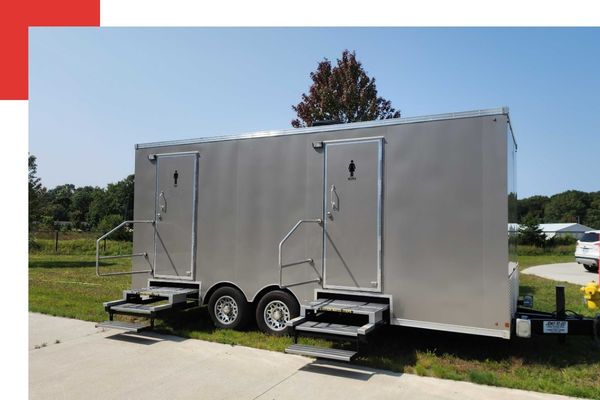 a portable restroom trailer parked at event