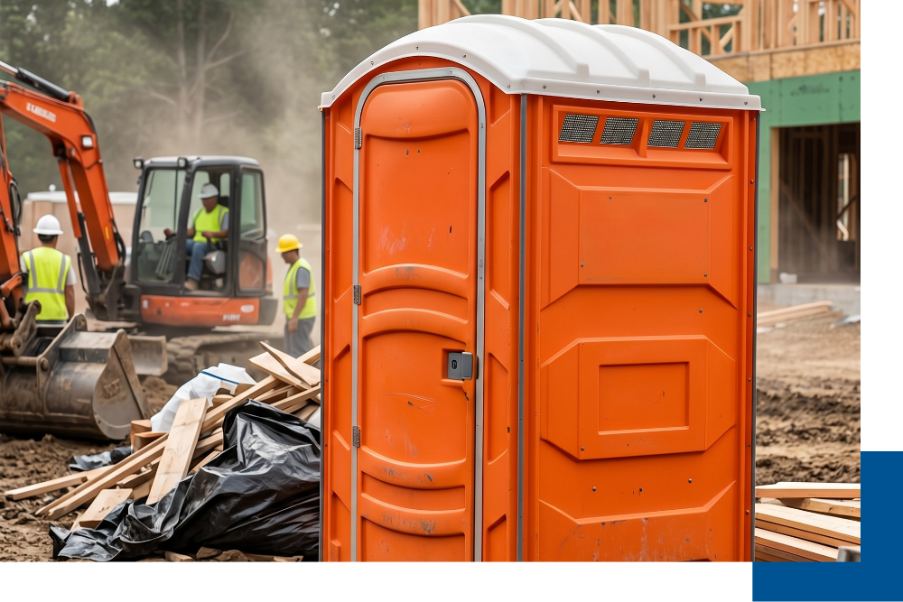 A durable porta john on an active Falmouth construction site, representing the efficient porta john service Falmouth provided by Caribou Services.